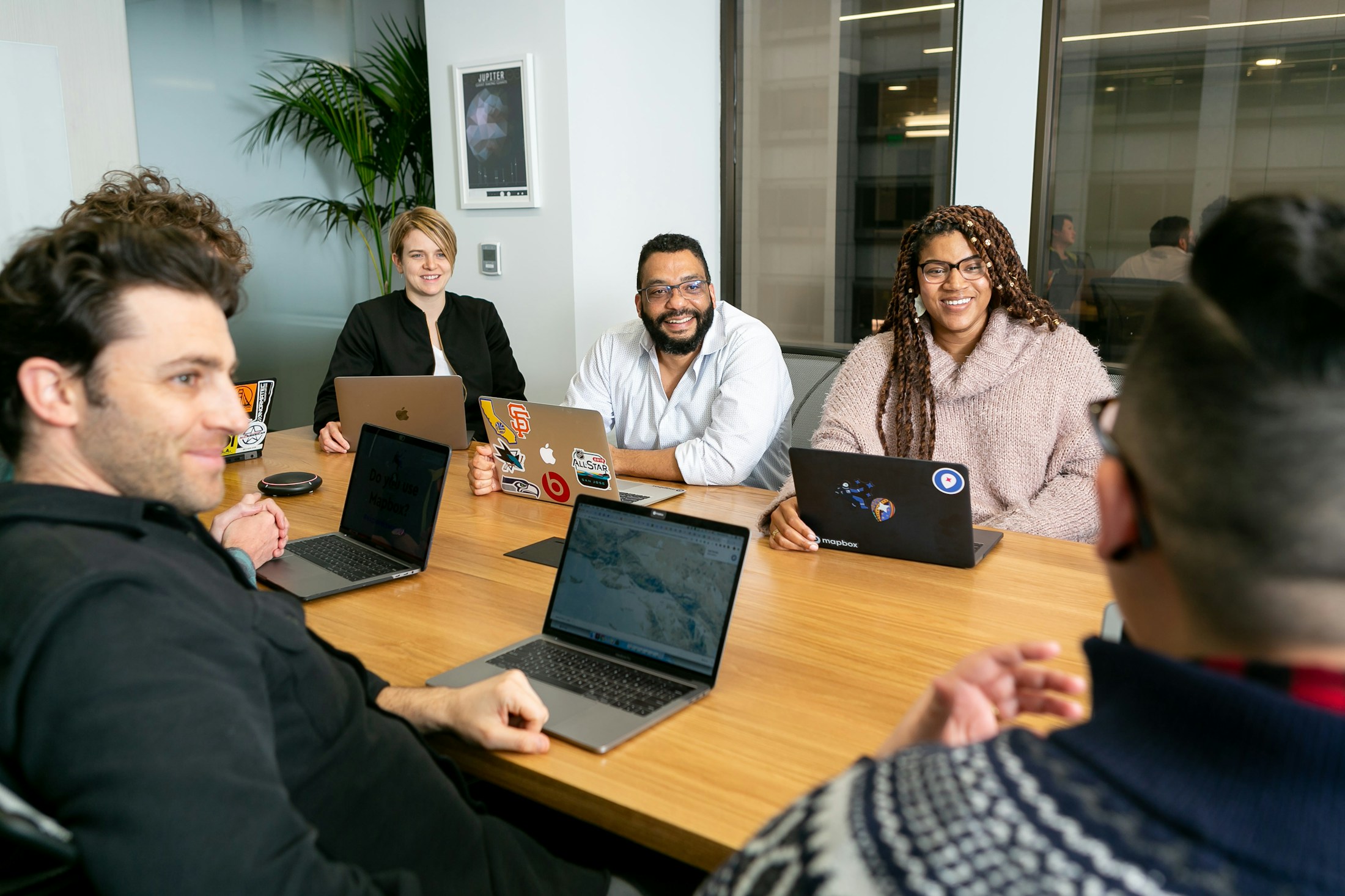 People using laptops in a boardroom discussion
