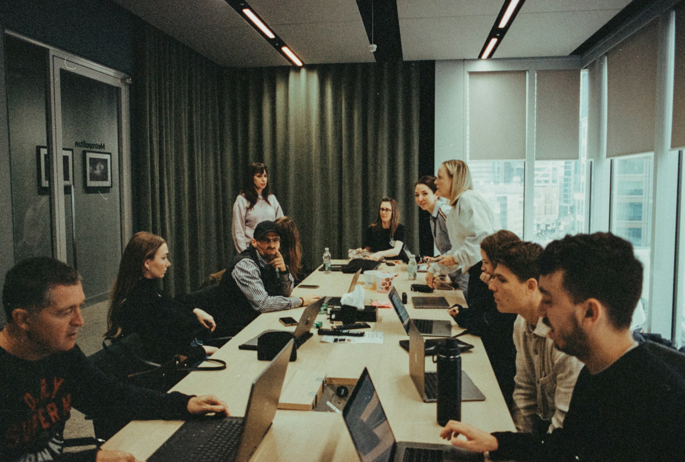Team planning around a table with laptops